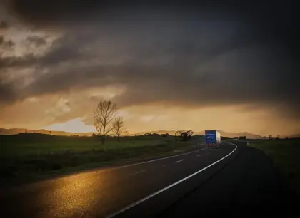Mainfreight truck on road at sunrise