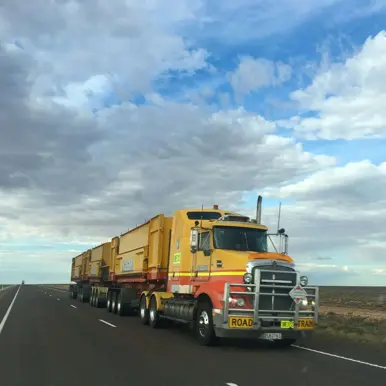 yellow road train on open highway