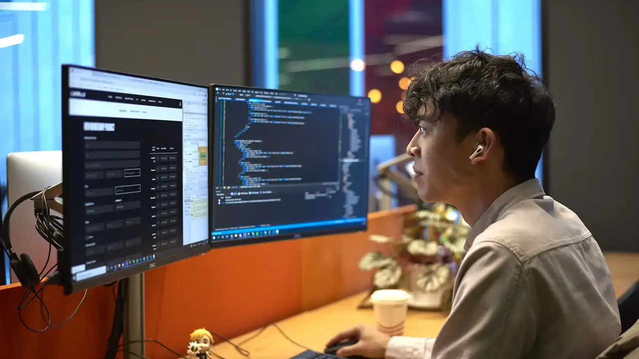 man coding on computer