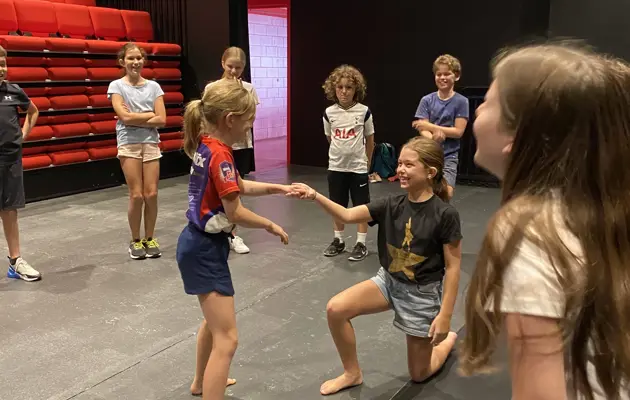 kids performing on stage loading=